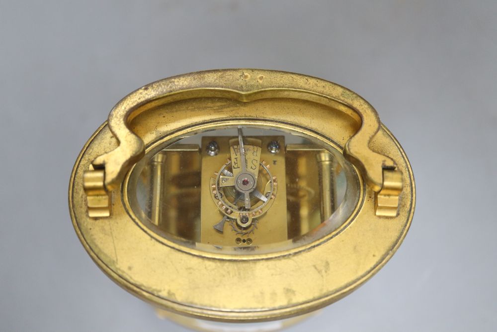 An oval brass carriage clock, height 12cm (handle down)